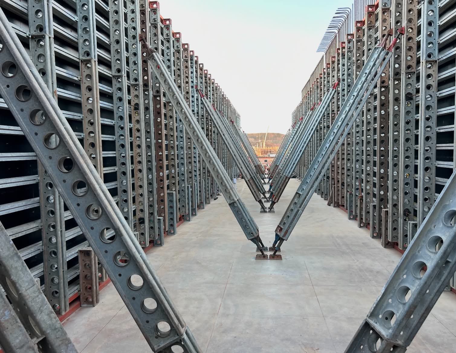 Symmetrical rows of steel formwork in a contractor yard