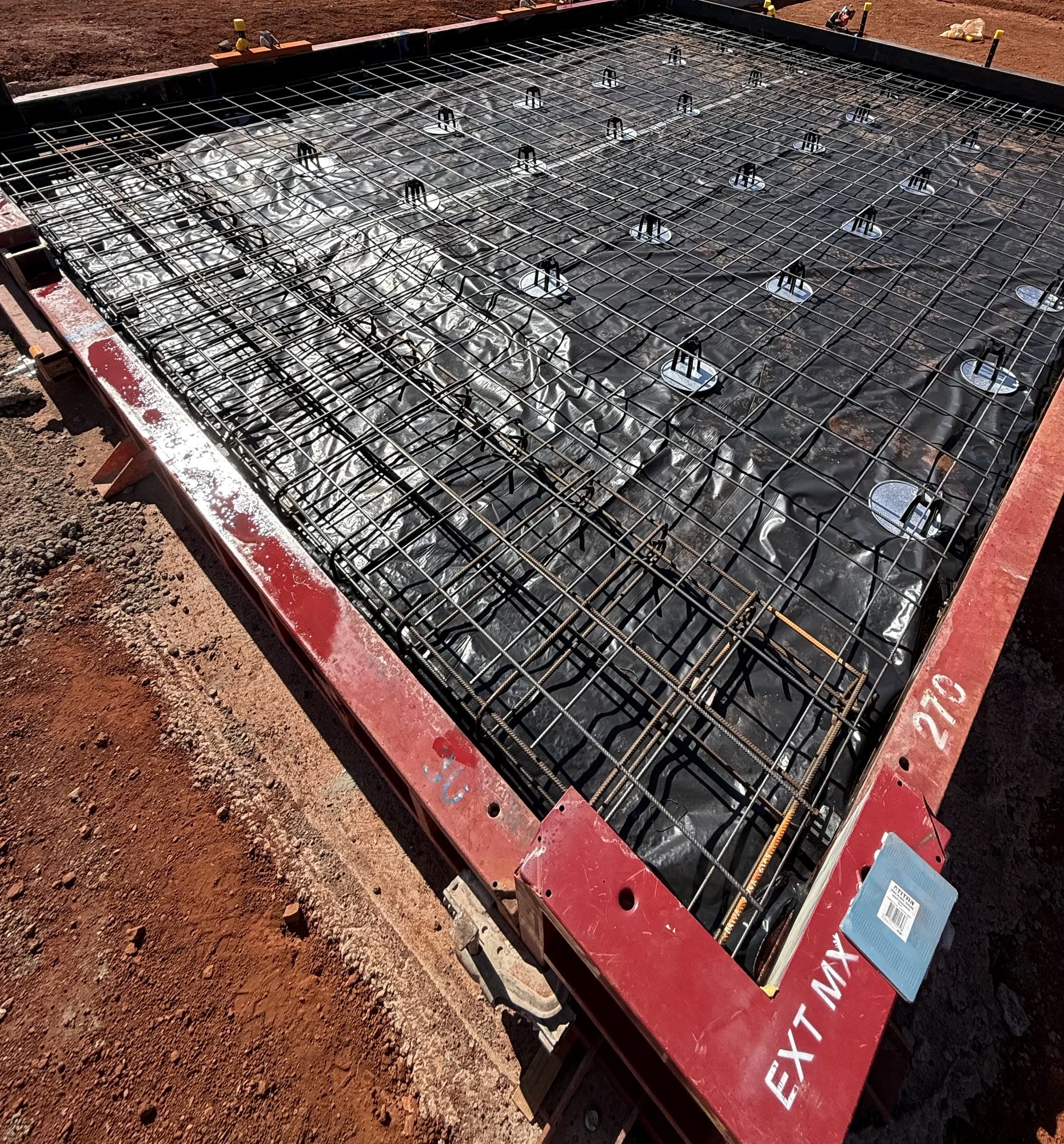 Prepared pad with mesh, rebar and chairs ready for inspection
